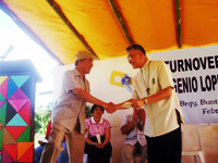 Lopez Group of Companies chair Oscar M. Lopez hands out his PhP 1M donation for the Jaro Cathedral to Archbishop Angel Lagdameo