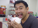 A model taking a bite of siopao