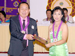 Evelyn Tan receives her Club Service Award from PDG Rene Mabilog