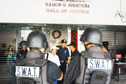 Members of the Special Weapons and Tactics (SWAT) unit of the Iloilo City Police Office secure the Ramon Avanceña Hall of Justice following a bomb threat received by a staff of Regional Trial Court Branch 31.