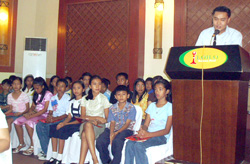 Donne Jone Sodusta speaks while the child writers and illustrators look on