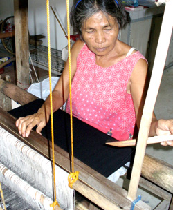 A weaver from Ana Cordova's weaving business in Oton