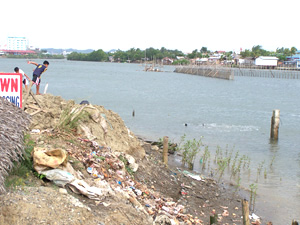 Two boys play at the bank of the Iloilo River near the Carpenters bridge in Brgy. Tabucan, Mandurriao district.