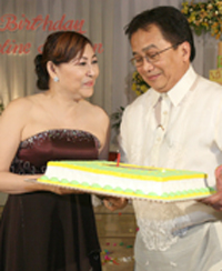 Dr. Rene Juaneza presenting a cake to Dr. johnson
