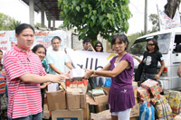 John Michael Ng, president of the Rotary Club of Metro Iloilo hands out donations to the faculty of DIRMES