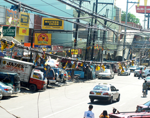 Various types of cables and wires are cluttered in this part of Delgado Street