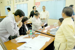 Liga ng mga Barangay president and ex-officio City Councilor Irene Ong (3rd from left) shows to her colleagues in the city council pictures of their trip to Baguio City recently. Ong along with 139 other barangay officials participated in the league's first ever mobile congress.