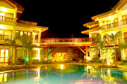 Facade, bridge and pool at night