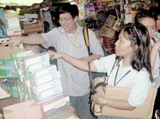 Industry Expert on Electrical Devices Engineer George Chua and Melecia Pait of DTI-Guimaras Provincial Office withdraw uncertified compact fluorescent lamps without the ICC mark during the enforcement activity May 8, 2008 in Iloilo City. Partly hidden are Felisa Judith Degala and Demar Solinap of DTI-Iloilo Provincial Office. 