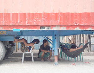 Workers at the Muelle Loney wharf take a rest