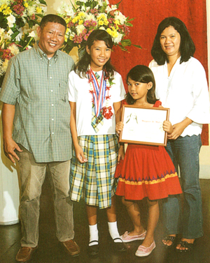 During her graduation with dad Hector, mom Mary Julie 