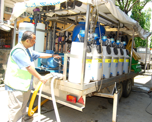 Ray Robles of Manila Water supervises the operation of the mobile water treatment plant