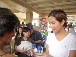 Celine Lopez helps in the distribution of relief goods to the typhoon victims.
