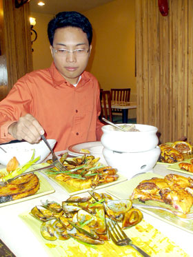 Lloyd Celis helps himself to Emilion's Hot Off The Grill delights.