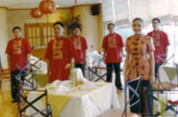 The Promenade's wait staff in a spectacular bright-red Chinese attire