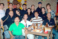 TNT men and women pose with (seated L-R) Liga ng Barangay President Wilson Acervo Sr, Brgy 3 Brgy Capt Dodoy Tobillo and Lawaan Brgy Capt Randee Albar.