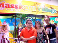 Manila guests pose at the village entrance for souvenir.