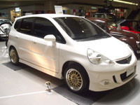 SPORTS SUBCOMPACT CAR. Owned by Gus Banusing, Jr., the modifications of this 2004 Honda Jazz car are: 1.3 IDsi engine, all Sony speakers and aplifiers, imported Concept One racing wheels, Fireze tires, three pieces LCD monitor, customized steering wheel, leather seatcovers, all imported Mugen front, side, rear skirts and Mugen spoiler.