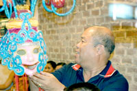 Congressman John Orola displays the masskara.