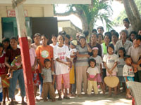 Beneficiaries await the distribution of relief goods.