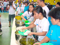 Personnel prepare food for the children