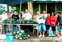 Centena with his farm workers and their produce.
