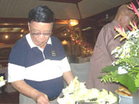 Birthday boy Toti Ramos looks down to check his green salad.