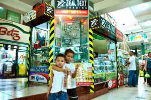 BETTER THAN BEGGING  These two boys, at a young age, already know how hard life is--they sell onions and garlic so they could earn money for their schooling inside Plazamart Mall in San Juan St., Bacolod City.