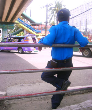 A traffic auxiliary posted under the Gen. Luna-Valeria overpass.