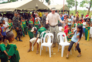 Staff Sgt. Kylie Boyle leads the children in playing the “Trip to Jerusalem”