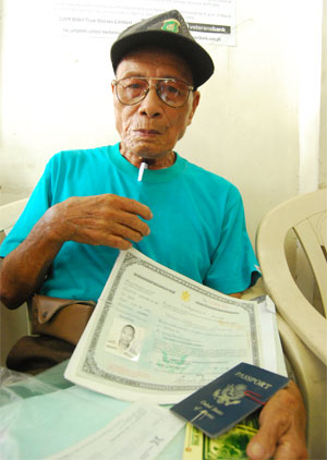 Eighty-eight year-old war veteran Nicanor Samilo with his military papers intact wait for his turn to be entertained inside the Philippine Veterans Affairs Office.