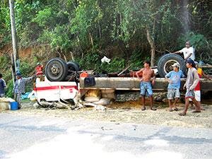 A cargo truck loaded with sacks of corn turned upside down after losing its brakes