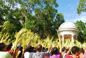 Devotees wave their palms in front of St. Anne Parish Church  in Molo District during Palm Sunday.