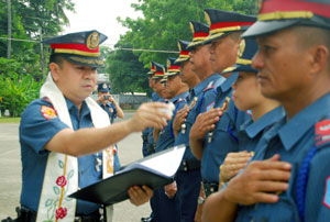 Police Supt. Jason D. Ortizo gives his blessing during the conferment of PNP Badge of Honor ceremony at Camp Martin Delgado yesterday.