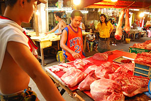 A man tries to buy pork from a dealer inside the Iloilo Central Market. Health officials reiterated that eating pork is safe amid fears of the spread of H1N1 virus.
