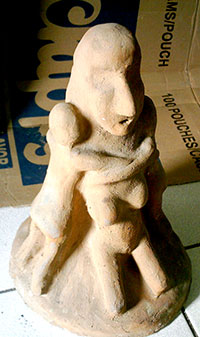 A terra cotta sculpture that echoes mother and children relation.