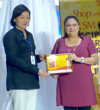 Claudette French-Salcedo receives her cetificate of participation for her cooking demo.