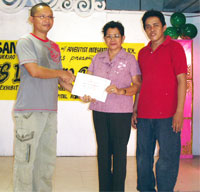 Angelo Duarte receives a certificate from Nenita Jandonero and Jonathan Jaleco.