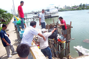 Iloilo City Hall personnel demolish a shanty standing on the Iloilo River at the Muelle Loney area.