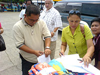 The signing of memorandum by Mayor Gumarin of Buenavista while Governor Felipe Nava looks on.