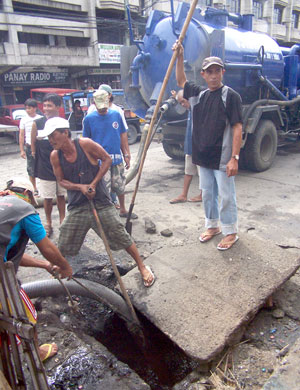Iloilo City Hall personnel clean up a clogged drainage along Valeria Ext. in the city proper with the use of a declogging machine with the onset of the rainy season.