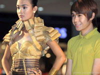 Djohn with a model wearing a gold outfit made of Filon, a petticoat fabric.