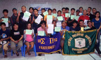 Fraternity members pose with Maezel Jeongco (seated, 2nd from left).