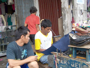 This man repairs just about anything, from shoes to umbrella to bags, etc.