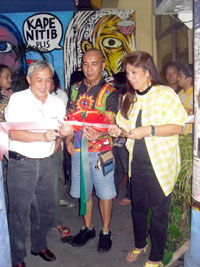 The artist leads the ribbon cutting.