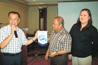 Skal Club International Cebu President Charles Lim hands over the SKAL Cebu banner to SKAL Bacolod President John Orola Jr and Secretary Pinky Hautea