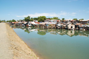Water from the Iloilo River divides the new boulevard being constructed in Brgy. Nabitasan, La Paz