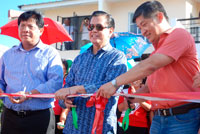 Ribbon cutting at the Monticello Villas Isabella model house. From left are Jimmy Fabia&ntilde;a, HDMF andPagIBIG president; VP Noli de Castro; and Gerry Choa, Profriends President.