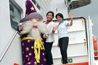 Eldar the Wizard, Cynthia R. Mamon, Ph.D., EK’s VP for SMILE (Sales, Marketing, Imagineering, Leisure and Entertainment) and Ava Engel, SuperFerry’s Executive Vice President and CEO wave as they go on board the SuperFerry.