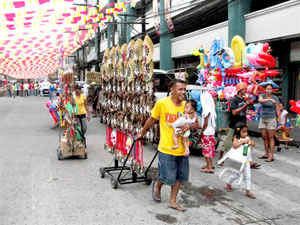 A man brings his two young children while selling masks